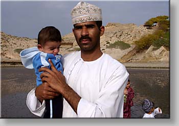 Omani family walking at the beach at Al-Sawadi