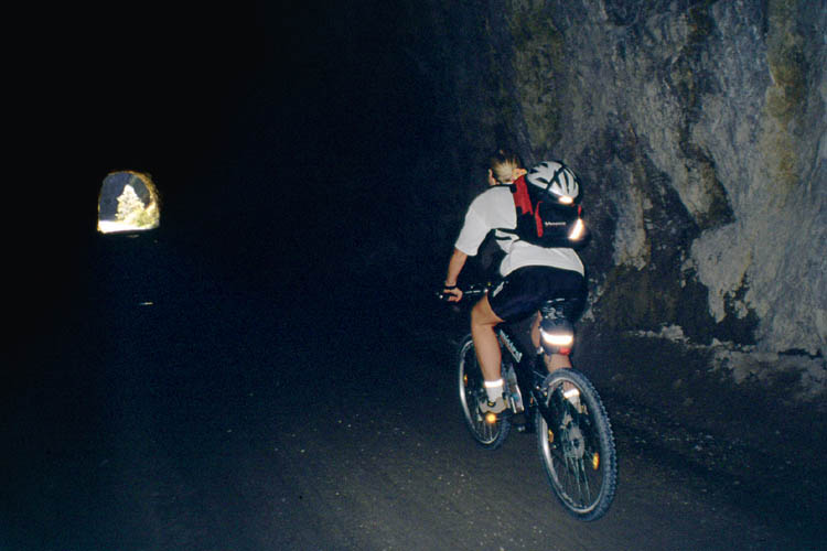 Inside a long tunnel on the former railroad track - click to go to next image